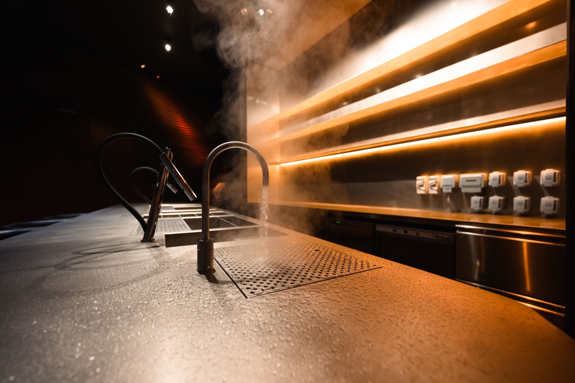 Close crop of vibration finish texture at hand distance on Myata bar top