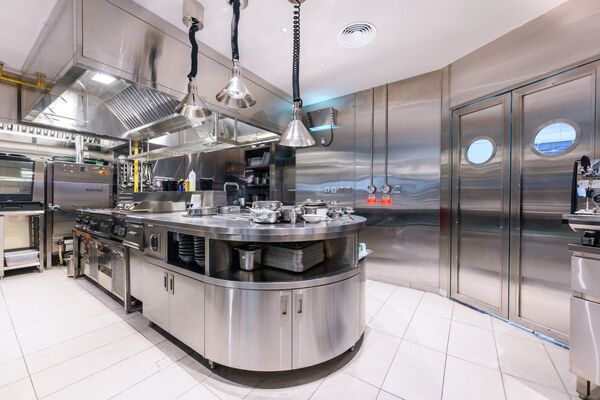 John Dory curved kitchen island with heat lamps, built by Cleresdyne