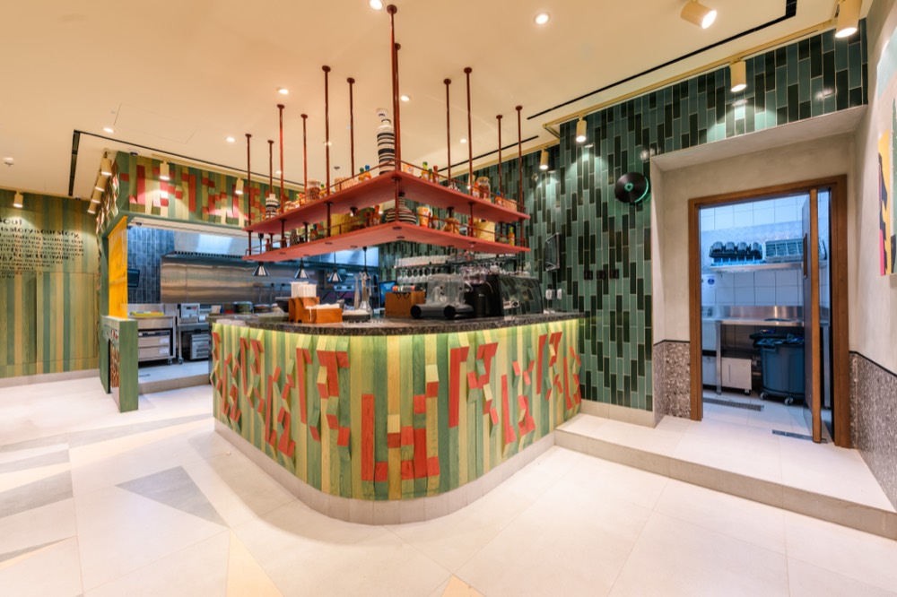 Nando's Damac Hills 2 front-of-house service counter with signature red and green finish, built by Cleresdyne