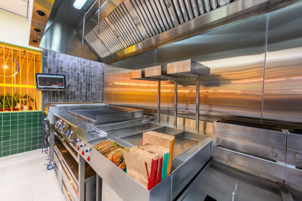Nando's Damac Hills 2 flame-grill line with heat lamps and green brand tiling, fitted by Cleresdyne